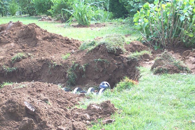 Excavated soil for a drain field in a sloping garden